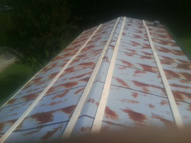 Rusted metal roof panels with new wood purlins before replacement — Storm Damage Roof Repair in Woodland by Roofing Brothers