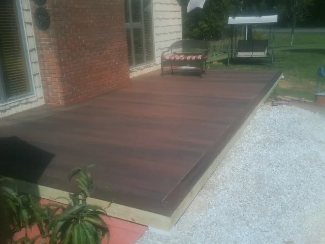 Freshly stained wood deck built against a brick home in Woodland
